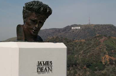 
                    The "Rebel Without a Cause" monument sits on the lawn of Griffith Observatory with the Hollywood sign in the background, March 2006.
                                            (Griffith Observatory)
                                        