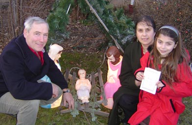 
                    John and Joan Leising, with their daughter Julia as they pose with baby Jesus in the manger.
                                            (Omar Fetouh)
                                        
