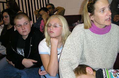 
                    Felicia Erickson and her children Tyler, 14, and Sydney, 11, waited in the bleachers to say good-bye to Jay. Seven-year-old Galen fell asleep in his mother's lap.
                                            (Pat Loeb)
                                        