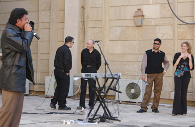 
                    Hussein Al-Assadi, an Iraqi, performs a microphone check for the band Groove Alliance in the Green Zone.
                                            (Gulf Region Division Public Affairs Office)
                                        