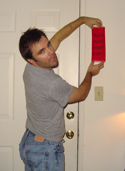 
                    Charlie hangs his lucky saying, or "Fai Chun," by the door. It follows the traditional Chinese form of four word phrases or words. In this case it's "Money, Money, Money, Money."
                                            (Wendy Mok)
                                        