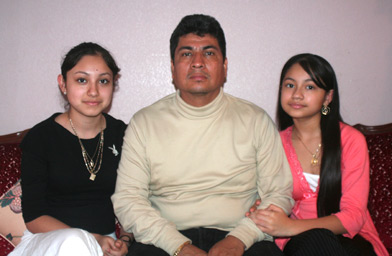 
                    Webb students Zaira and Dulce Garcia sit with their father, Martin Garcia, in their Austin home.
                                            (Michael May)
                                        