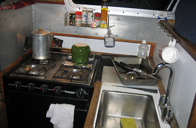 
                    The galley on the Ursual B, where Ernie cooked his pot roast.  Ernie keeps a week's worth of groceries on his boat, in case the fishing's so good that he doesn't want to go back to land to resupply.
                                            (Krissy Clark)
                                        