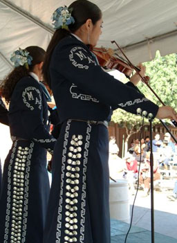 
                    The mariachi uniform, or traje, derives from rodeo riding gear. Mariachi Aztlan gets its uniforms from Mexico. Each has to be fitted by a tailor. Uniforms cost more than $500 each, and the group covers the costs by playing gigs around town.
                                            (Julia Barton)
                                        