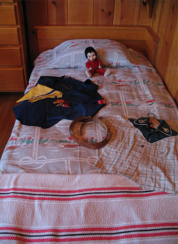 
                    A scouting uniform, cowboy shirt, and stuffed animal lie on the bed in George W. Bush's childhood bedroom.
                                            (Katy Floyd)
                                        