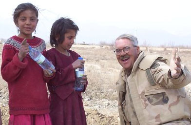 
                    Dewey with two Afghan girls in 2003 outside of Bagram. The soldiers were building a road for the local Afghans.
                                            (James Dewey)
                                        