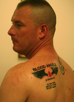 
                    Medic Clint McCullough shows off his memorial tattoo with the name of his unit, and the names of three friends who died.
                                            (Michael May)
                                        