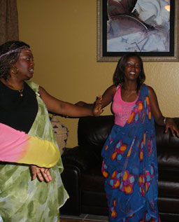 
                    Nadia Kassongo and Ines Kazeneza dance a traditional Burundian dance in Jeanne's living room.
                                            (Ann Heppermann and Kara Oehler)
                                        