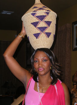 
                    Jackeline Simbandushe shows off the traditional Burundian baskets and how women carry it.
                                            (Ann Heppermann and Kara Oehler)
                                        