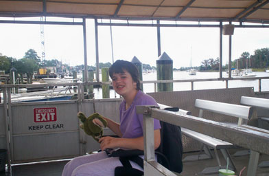 
                    Katie Rose on Captain Rod's pontoon boat in Georgetown, SC.  Her companion is a stuffed alligator.
                                            (Karen Tips)
                                        