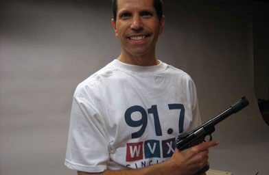 
                    Eric, in his public radio t-shirt, with his gun. He likes to listen to "Fresh Air" while shooting.
                                            (Katie Orr)
                                        