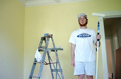 
                    Homeowner Josh Moore pauses in mid-paint. Moore began renovating his house before he moved in two and a half years ago.
                                            (John Moe)
                                        