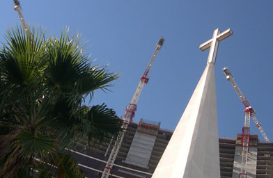 
                    The spire of Guardian Angel Cathedral, in the shadow of the newest wing of the Wynn Hotel on the Las Vegas Strip.  Las Vegas has the fastest growing Catholic Diocese in the nation.
                                            (Krissy Clark)
                                        