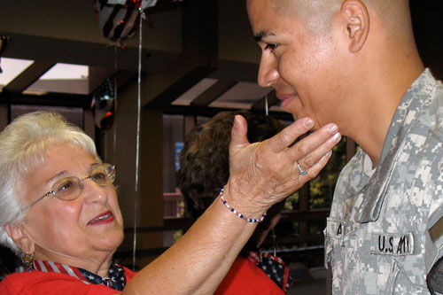 
                    "Huggin and Kissin Grandma" Constance Carman gives a goodbye hug to another soldier.
                                            (Julia Barton)
                                        