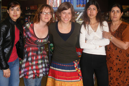 
                    Leena, Mariya and their mother, Shafiqa Sher Ali pose for a picture with producers Ann Heppermann and Kara Oehler in Mariya's store, Amarillo International Foods. (From Left to Right: Leena Sher Ali, Ann Heppermann, Kara Oehler, Mariya Sher Ali, and Shafiqa Sher Ali.)
                                            (Ann Heppermann and Kara Oehler)
                                        