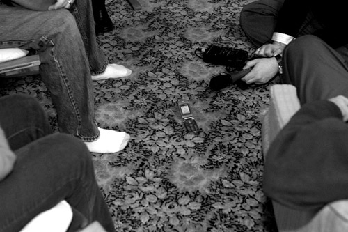 
                    People in the Willis's Rockwell city living room listen to Senator Barack Obama on Katie Malkin's cell phone.  Malkin is a field ogranizer for Obama's campaign.  Senator Obama gave this cell phone speech during pre-caucus events held across the state December 13, 2007.
                                            (Sarah Mercier)
                                        