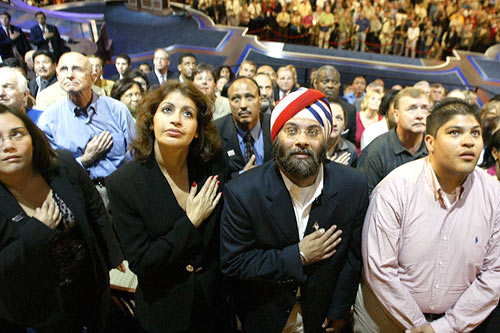 
                    Delegates to the 2004 Democratic National Convention singing the National Anthem.
                                            (Robyn Beck/AFP/Getty Images)
                                        