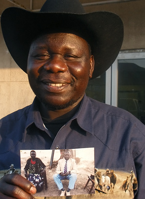 
                    Kaunda Mogga, owner of the Sudanese Center, holds the thing he brought with him: a photo of his parents.
                                            (Kara Oehler & Ann Hepperman)
                                        