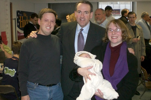 
                    The McNarney family and presidential candidate Mike Huckabee smile despite the angry Ron Paul protesters that bombarded the former Ark. governor's Iowa campaign headquarters.
                                            (Courtesy Michael McNarney)
                                        