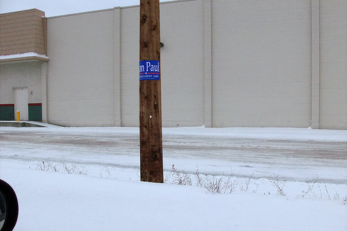 
                    Kalispell, Mont., is covered both by snow and Ron Paul signs this time of year. Many people have the signs in their yards and it's not uncommon to see them affixed to random telephone poles like this one north of downtown.
                                            (John Moe)
                                        
