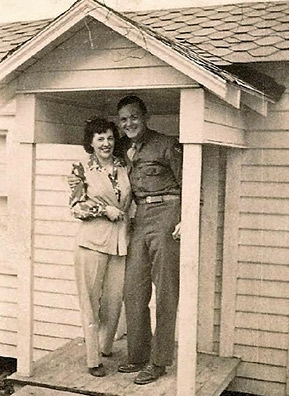 
                    WWII airman and his wife on the porch of Lucinda's playhouse, circa 1944.
                                            (Courtesy Lucinda Alsobrook Coulter-Burbach)
                                        
