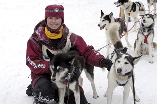 
                    Musher Jennifer Freking hugs her dogs at the finish line of the 2006 race. Freking is a veterinarian who operates a racing dog kennel with her husband, Blake.
                                            (Gary Meinz)
                                        
