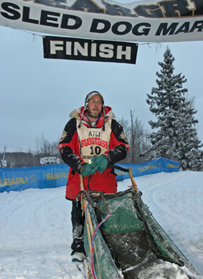 
                    Four days after beginning the 2006 Beargrease Sled Dog Race, Keith Ali crosses the finish line as its winner.
                                            (Kit Larson)
                                        
