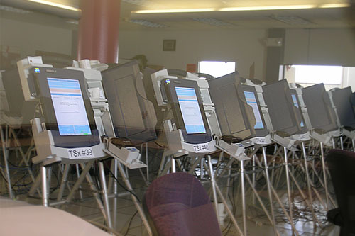
                    Diebold electronic voting machines sit behind glass in Cuyahoga County's Board of Elections. Units like this crashed during the November 2007 primary and the county is switching back to paper ballots.
                                            (Mhari Saito)
                                        