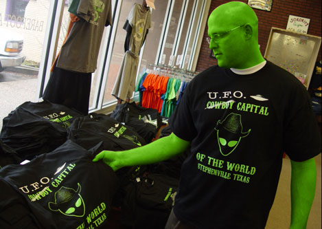 
                    Alienized Barefoot Athletics store manager Matt Shaw showing off their popular UFO sighting shirts.
                                            (Joaquin Cortez)
                                        