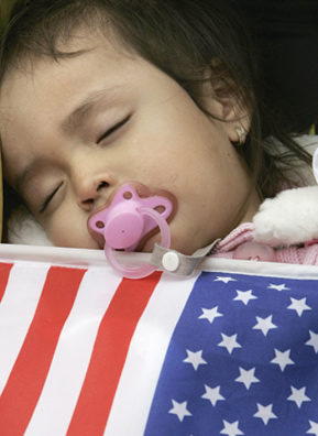 
                    A baby sleeps during a rally for immigrant family and worker rights in New York City's Union Square in May 2007.
                                            (STAN HONDA/Getty Images)
                                        