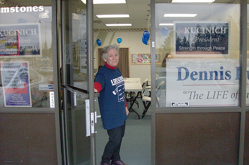 
                    Rebecca Wolfe, the Washington state coordinator for the Dennis Kucinich campaign, stands outside the storefront headquarters.
                                            (John Moe)
                                        
