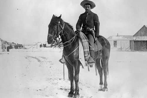 
                    A Buffalo Soldier from Denver's 9th Cavalry on snow-covered ground in 1890.
                                            (- - -)
                                        