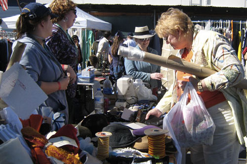 
                    A costumer sells ribbons and fabric.
                                            (Paula Kaatz)
                                        