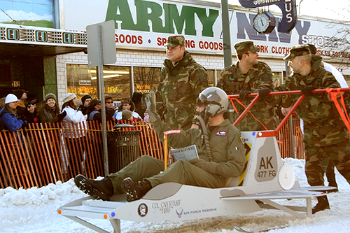 
                    Elmendorf Air Force Base fly boys zip past the crowd that turned out to watch the Outhouse races.
                                            (Anchorage Convention &Visitors Bureau/Cady Lister)
                                        