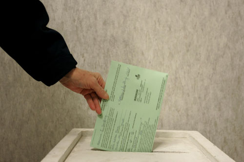 
                    A woman drops her ballot in a voter box at One Government Center Mar. 2, 2008 in Toledo, Ohio.
                                            (J.D. Pooley/Getty Images)
                                        