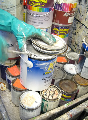 
                    Opening cans of paint at Sunset Scavenger. Before being mixed into larger drums, workers separate oil-based paints from water-based products.
                                            (Nancy Mullane)
                                        