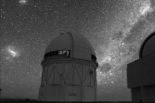 
                    The Blanco Telescope at the Cerro Tololo Inter-American Observatory, high in the Andes in Chile. This digital image was recorded with a sensitive detector intended for astronomical imaging -- the observatory is lit solely by starlight.
                                            (Roger Smith/AURA/NOAO/NSF)
                                        