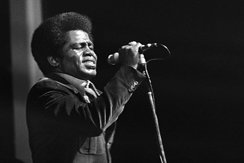 
                    James Brown performs at the Olympia Hall in Paris, 1971. Brown is credited for calming racial tensions with a live performance in Boston three years earlier in the aftermath of the Rev. Martin Luther King Jr.'s assassination.
                                            (AFP/Getty Images)
                                        