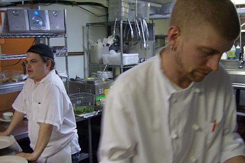 
                    Chef Ian Pierce and "Niblet" in the Cafe 128 kitchen
                                            (Michael May)
                                        