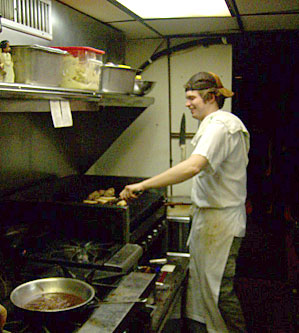 
                    "BFO" mans the grill at Cafe 128
                                            (Michael May)
                                        