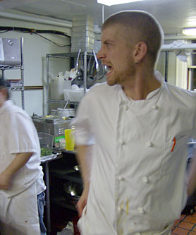 
                    Chef Ian Pierce barks orders in the kitchen of Cafe 128 as the dinner rush reaches its height.
                                            (Michael May)
                                        