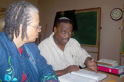
                    Rabbi Capers Funnye studies with temple member Dinah bat Levi.
                                            (Photo courtesy Temple Beth Shalom)
                                        