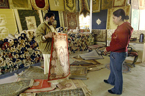 
                    Maribel Baez, a sailor from the aircraft carrier USS Dwight D. Eisenhower, shops for carpets in Dubai during a guided tour.
                                            (Matthew D. Leistikow)
                                        