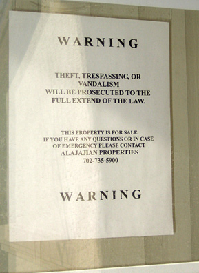 
                    A sign on a foreclosed house meant to deter vandals.
                                            (Krissy Clark)
                                        