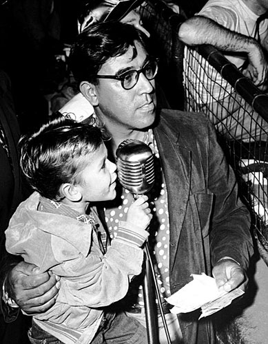 
                    Joe Hernandez calls a celebrity baseball game with the assistance of his stepgrandson, Michael.
                                            (Courtesy Caballo Press of Ann Arbor and Frank Hernandez. All rights reserved.)
                                        