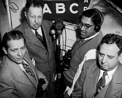 
                    Joe Hernandez prepares to go live with his counterparts for a national ABC radio broadcast. Hernandez provided color commentary for broadcasts and then headed to the booth to call a race.
                                            (Courtesy Caballo Press of Ann Arbor and Frank Hernandez. All rights reserved.)
                                        