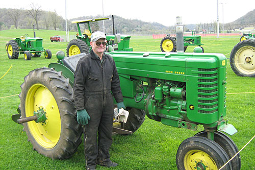 
                    Art Freymiller in front of a vintage John Deere tractor. He owns 27 tractors, worth a small fortune. But he has no plans to ever sell them.
                                            (Jesse Millner)
                                        
