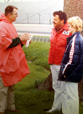 
                    May 9th, 1984: Art and Kathy Koch celebrate their 25th wedding anniversary with Father Pat (in poncho) who officiates as the couple renew their vows at the Speedway infield.
                                            (Courtesy Art Koch)
                                        