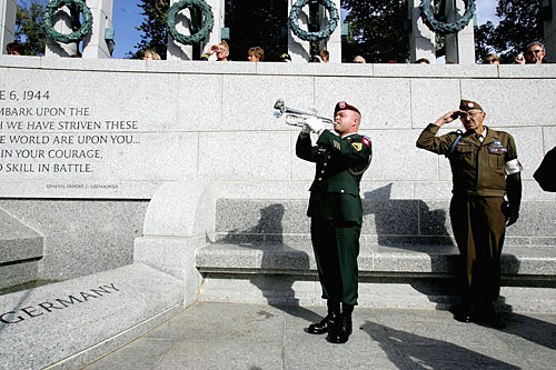 
                    A trumpeter plays taps as Korean War veteran Edward Bottge salutes during a Veterans Day ceremony at the World War II memorial in Washington, D.C.
                                            (Joe Raedle/Getty Images)
                                        