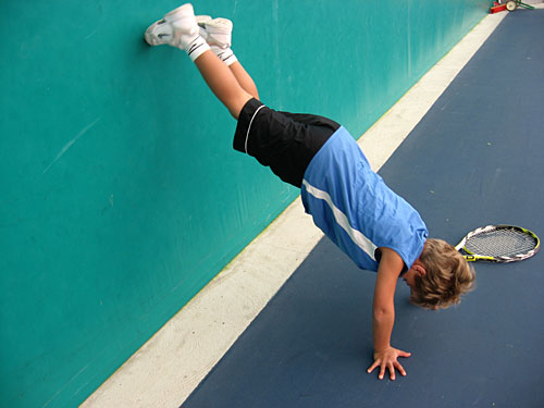 
                    Jan has a tendency to goof-off, like any 6-year-old. Here, he shimmies up a wall backwards to attempt a handstand.
                                            (Rene Gutel)
                                        
